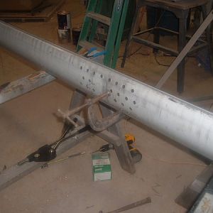 The two ends of the mast joined and riveted in an alternating pattern with out the spreader base mounts attached, curing